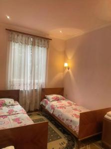a bedroom with two beds and a window at Nina B&B in Dilijan +31 photos