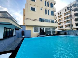 a swimming pool in front of a building at USABAI Riverside Boutique Hotel in Chanthaburi