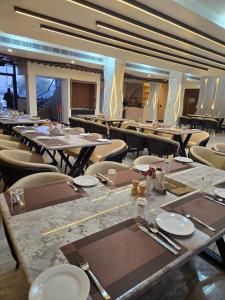 a large dining room with tables and chairs and sidx sidx sidx at Hotel KNG Grand in Fatehpur Sīkri