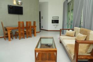 a living room with a couch and a table at River View Stay in Latpandura