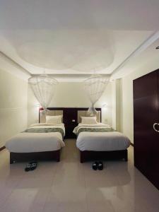 two beds in a hotel room with two at Wynn hotel in Bahir Dar