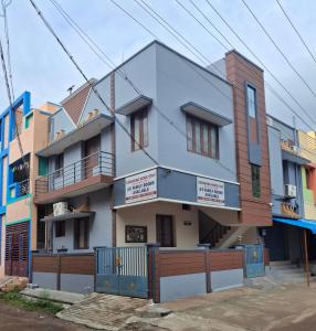 Un edificio con letreros en el costado. en Saravana HomeStay, en Tiruvannāmalai