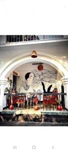 a dining room with a painting on the wall at Pearl House Residency in Jāmb