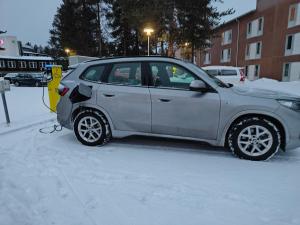 a small car parked in the snow next to a parking meter at Kuusamon Lampitropiikki 108 m2 Holiday Home in Kuusamo