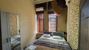 a bedroom with a bed in a room with a window at Hamza Hostel in Katartal +1 photo