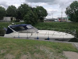 a white boat is docked in the water at Motoryacht ELENA in Eeklo