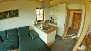a living room with a couch and a kitchen at Chalets Frauenalpe in Sankt Lorenzen ob Murau +15 photos