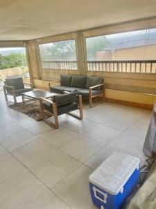 a living room with a couch and a table at Gugu's Holiday Home in Durban