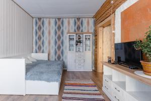 a bedroom with a bed and a flat screen tv at Rakvere Old Town Home in Rakvere +9 photos