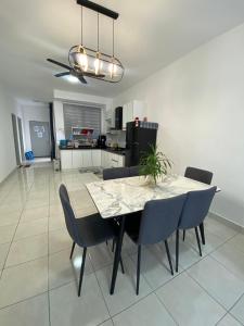 a dining room and kitchen with a table and chairs at Alfie Homestay Bangi in Kajang