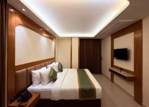 a hotel room with a bed and a flat screen tv at hotel Green view in Baharampur