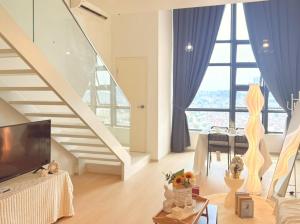 a living room with a tv and a staircase at Urban Loft MRT Convenience KLCC Nearby in EKO CHERAS in Kuala Lumpur