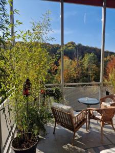 a patio with two chairs and a table on a balcony at Lumi, modernes Attika-Refugium in Derendingen