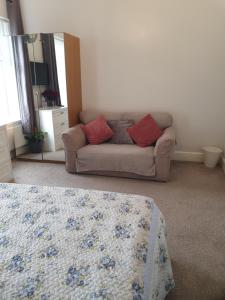 a living room with a couch and a bed at Private Double Room in Cardiff in Cardiff
