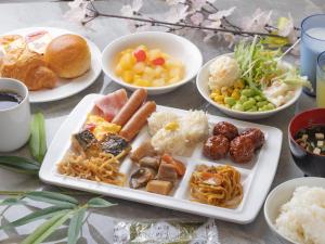 a table with plates of food and bowls of food at APA Hotel Saga Ekimae Chuo in Saga