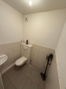 a small bathroom with a toilet and a sink at Bartappart in Bartenheim