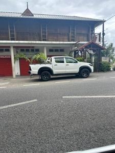 a white truck parked on the side of a street at Royal Attitude in Port Mathurin