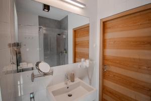a bathroom with a sink and a mirror at Gasthaus Post in Matrei in Osttirol +37 photos