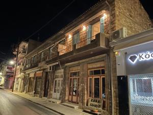 a building with a sign on the side of a street at Loutra Edipsou Serenity Suites in Loutra Edipsou