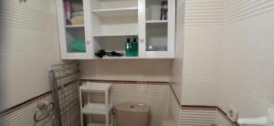 a small bathroom with a toilet and white cabinets at Tramuntana Beach in Calafell +16 photos