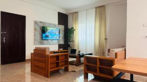 a living room with a table and a couch at Confortable Appartement MERCURE, près de la plage in Mpita
