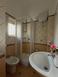 a bathroom with a sink and a shower and a tub at Guzzolini Camere & Relax in Camigliatello Silano
