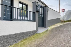 a person looking out the window of a house at Casa dos Anjos, a Home in Madeira in Faial