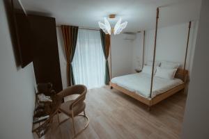 a room with a swing bed and a chair at Butterfly in Hunedoara
