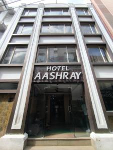 a hotel ashtaraya sign on the front of a building at Hotel Aashray in Haridwār