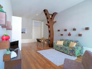 a living room with a couch and a tree at FLH Porto Portuguese Apartments in Porto