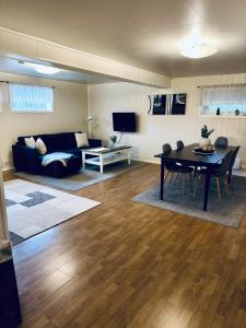 una sala de estar con un sofá y una mesa en Stranda Apartment, en Senja