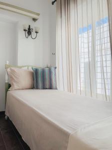 a large white bed in a room with a window at La Maison de haut in Tunis