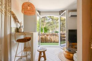 a living room with a large glass door leading to a patio at Une perle au bord de l'eau in La Ciotat
