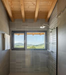 a bathroom with a window and a shower at ATEALAIA by Urdaibai Experience in Forua
