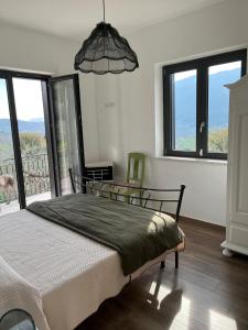 a bedroom with a bed and a large window at La Rosa di Tempalta in Roccadaspide