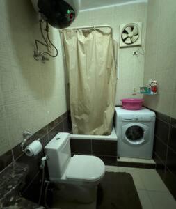 a small bathroom with a toilet and a sink at Cozy Townhouse, with back yard (98) in Sheikh Zayed +20 photos