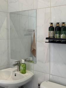 a bathroom with a sink and a mirror and a toilet at Nong Hoi Nest, New Townhome with Positive Pressure Air Purifier in Chiang Mai +38 photos