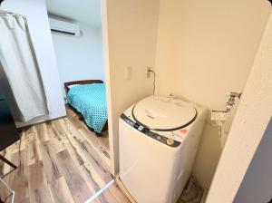a small room with a washing machine in a room at Small stay in Tokyo in Tokyo +4 photos