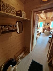 a room with a wooden wall with a mirror at Chalet des Aigles Reallon in Réallon