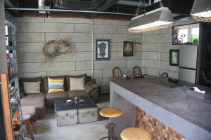 a living room with a bar and a couch at The EKAI in Toyohashi