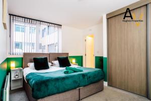 a bedroom with a large bed in a room at Luxury Two-Bedroom Apartment - Free Wi-Fi, Close to Station, Ideal for Relocation Guests by AV Hughes Properties in Milton Keynes