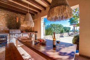 a kitchen with a table with wine bottles and glasses at Finca Mar des Teix in Manacor