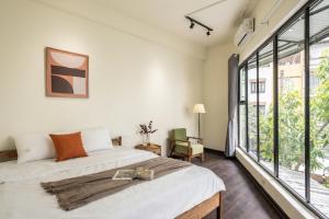 a bedroom with a bed and a large window at The Celestial Reef Hanoi-Stylish Stay with Rooftop Pool & Free Laundry-Middle Old Quarter in Hanoi