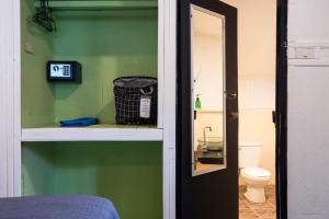 a room with a bathroom with a toilet and a mirror at Mook Lanta Eco Resort in Ko Lanta +101 photos