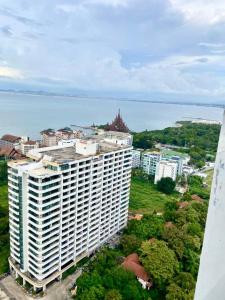 an aerial view of a large white building next to the water at Riviera Wongamat in Pattaya North