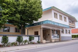 a building on the corner of a street at Hotel Drescher in Mörbisch am See