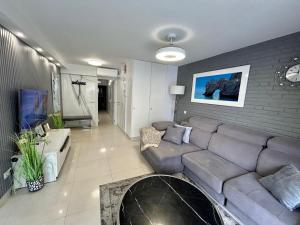 a living room with a couch and a fireplace at Gandia Playa Apartamento Elizabeth con vistas al mar in Gandía