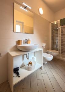 a bathroom with a sink and a toilet at BelSorrisoVarese - Elegance City Residence Private Parking -Reservation Required- in Varese