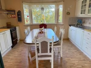 a kitchen with a table and chairs in it at Great House with a panoramic view in Storsæter