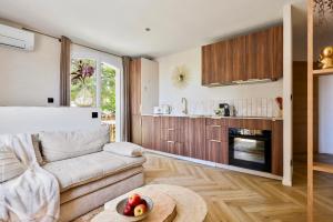 a living room with a couch and a table at De l'élégance au bord de l'eau in La Ciotat